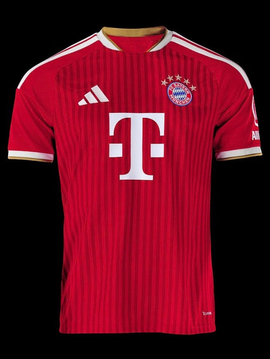 Kitted Up Bayern Munich 2026/2027 home jersey in red with white stripes, gold trim, and team crest on black background