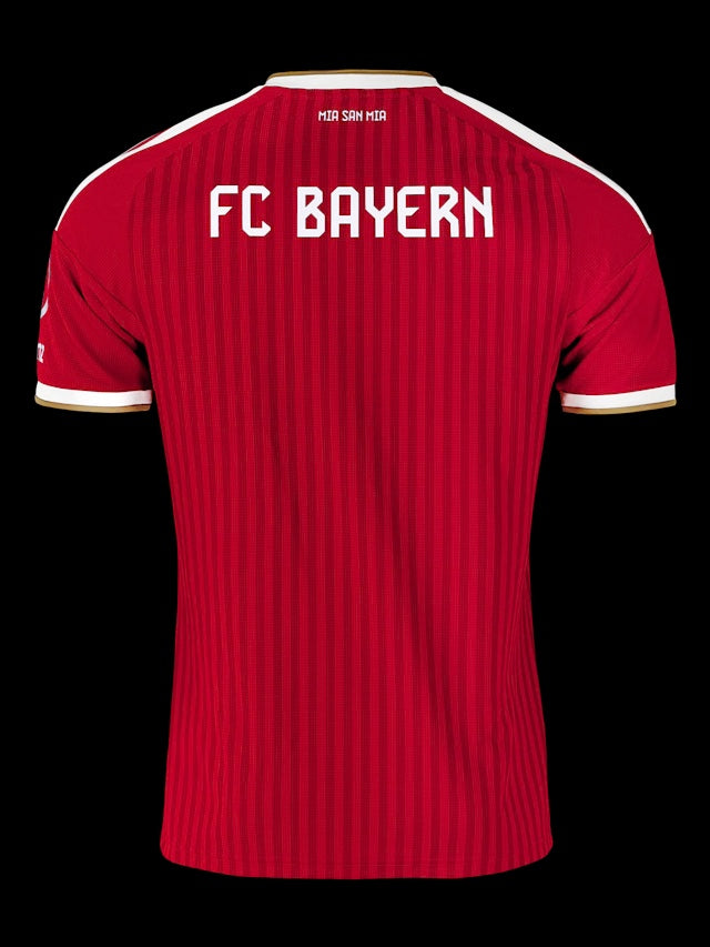 Back view of Kitted Up Bayern Munich 2026/2027 kids home jersey in red with white text and gold trim details.
