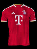 Kitted Up Bayern Munich 2026/2027 kids home jersey in red with white stripes and gold trim details.
