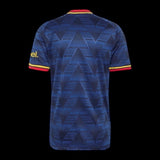 Back view of Kitted Up Manchester United 2026/2027 kids home jersey in dark blue with geometric pattern and red trim.