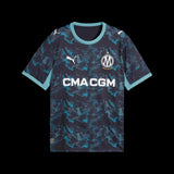 Kitted Up Marseille 2026/2027 kids away football jersey in dark blue with a teal abstract pattern and white logos.