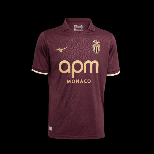 Kitted Up Monaco 2026/2027 away football jersey in dark burgundy with gold accents and a subtle geometric pattern.
