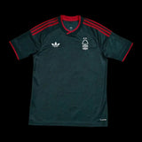 Kitted Up Nottingham Forest 2026/2027 away football jersey in dark green with red accents and white logos.