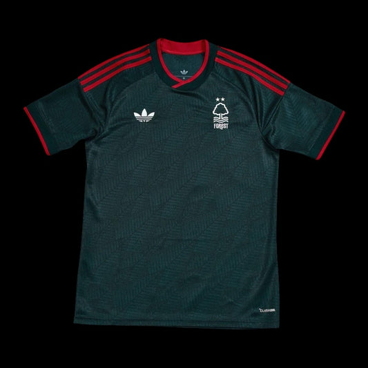 Kitted Up Nottingham Forest 2026/2027 kids away jersey in dark green with red accents and white logo details.