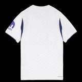 Kitted Up Tottenham Hotspur 2026/2027 kids home jersey, white with purple sleeve accents and textured fabric detail.